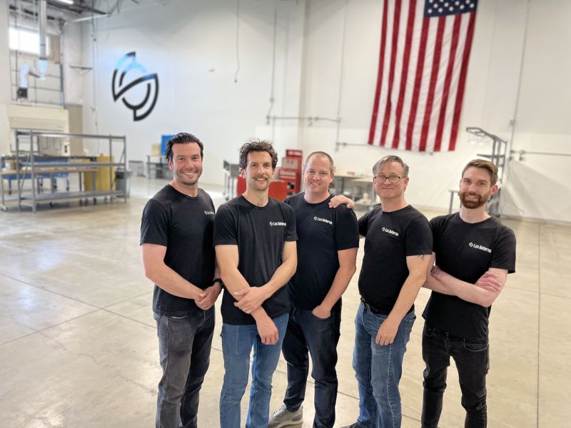 Founding team of Lux Aeterna standing in manufacturing floor